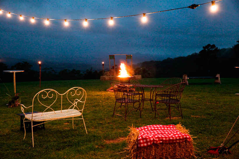 weddings at maleny retreat night lights, fire, haybales